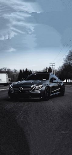 a black car is parked on the street