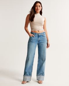 Our Curve Love low rise baggy jeans in a medium wash with a cuffed hem. This fit features a 8.5” low rise, is slightly relaxed at waist and hips, and eases at the thigh into a baggy, full-length leg shape. We recommend buying your true size for a baggier fit. Size down for a closer fit. The viral fit that eliminates waist gap: Curve Love features additional room through the hip and thigh for curve-hugging comfort. This jean is made from our vintage stretch fabric which features both an authentic Abercrombie And Fitch Outfit, Low Rise Baggy Jeans, Baggy Jean, Abercrombie Jeans, Love Jeans, Chic Top, Stretchy Jeans, Jeans For Short Women, Baggy Jeans