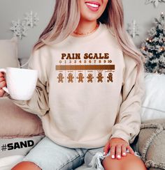 Gingerbread Pain Scale Sweatshirt,Nurse Christmas Sweatshirt,Gingerbread Cookie Shirt,Cute Christmas Tee,Nurse Xmas Gift,Funny Nurse Sweater ---> Important Notes About Sizing and Color : Our products are made to order just for you. For this reason, we do not accept returns or exchanges if there is nothing wrong on our end. To be able to get the perfect fit, please refer to our color and size charts before placing the order. If you have any questions, please do not hesitate to contact to us ! ---> Product Information: - (Sweatshirts) Solid colors such as black, white and maroon are 50% cotton and 50% polyester. Heather colors are 40% cotton and 60% polyester. - (T-shirts and Long Sleeve T-shirts) Solid colors such as black, white and pink are 100% cotton. Heather colors are 52% cotton and 4 Nurse Christmas Sweater, Nurse Sweater, Pain Scale, Cookie Shirt, Funny Nurse, Nurse Christmas, Gingerbread Cookie, Nurse Humor, Branded Sweatshirts