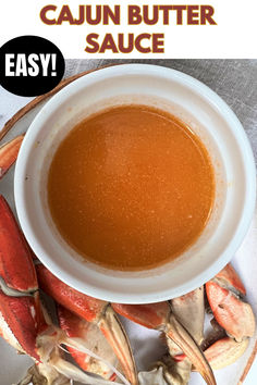 image of cajun seafood butter sauce in a bowl next to crab legs