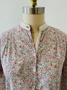 Sweet Floral Blouse Made by Cacharel Vintage from the late 1970's or early 1980's Floral cotton print that either is or resembles a Liberty Print Has a corduroy collar There are some breakage in the fabric near the neck It has been mended but still visible if looked at closely The blouse does have signs of wear but it still has a lot of life in it Condition is reflected in the price Size Small Pit to pit - 19" Shirt length -24" Sleeve length - 23" Cottagecore Cotton Blouse With Floral Print, Cottagecore Floral Cotton Blouse, Floral Print Cotton Blouse With Collar, Cotton Blouse With Floral Print And Collar, Fall Cotton Blouse With Vintage Print, Collared Cotton Blouse With Floral Print, Spring Cotton Blouse With Vintage Print, Cotton Floral Print Blouse For Daywear, Vintage Cotton Patterned Blouse