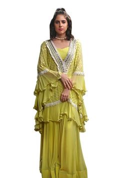 Lime green frilly batwing sleeves kaftan with all over mirror jaal embroidery and crochet, sequins and cowrie shell embroidered neckline. Paired with a three kali flared pant and a crop top. - Aza Fashions Bohemian Georgette Dress With Cape Sleeves, Green Cape Sleeves Sets For Eid, Green Cape Sleeve Sets For Eid, Green Chikankari Embroidery Kaftan For Wedding, Eid Kaftan With Mirror Work And Cape Sleeves, Georgette Dresses With Cape Sleeves For Festivals, Bohemian Georgette Sets With Cape Sleeves, Bohemian Pista Green Dress For Festive Occasions, Bohemian Eid Dresses With Cape Sleeves