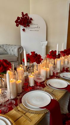 the table is set with red roses and candles for an elegant valentine's day dinner