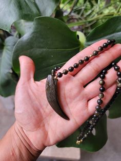 Obsidian Necklace, Golden Sheen Obsidian Necklace, Long Necklace, Beaded Necklace, Hand Knotted, Unisex, Boho Necklace, Wolf Necklace, Gold Necklace Beautiful 6mm golden sheen Obsidian beads hand knotted for security. The small gold beads are 14k gold and the clasp, extender are stainless steel. The pendant is also golden sheen Obsidian and is 59mm long. The shape is like an ivory tusk, slight curved. Obsidian Necklace With 8mm Beads As Gift, Obsidian Pendant Amulet Necklace, Obsidian Amulet Pendant Necklace, Obsidian Gemstone Beads Necklace For Meditation, Handmade Obsidian Necklaces For Meditation, Obsidian Necklace With Gemstone Beads As Gift, Obsidian Gemstone Beads Necklace For Gift, Obsidian Gemstone Beads Necklace As Gift, Black Hand-strung Amulet Necklace