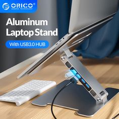 an aluminum laptop stand with usb and hub plugged in to it on a wooden desk