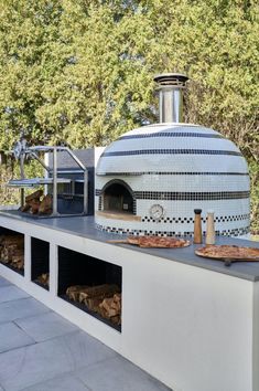 an outdoor pizza oven with lots of food in it