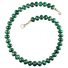 18 Inch slightly oval, not quite round faceted emerald necklace. There are tiny goldy daisies accenting the glitter of the emerald facets. All you emerald lovers are in luck with this beauty, it will be your 'go to' necklace from now on. It's the perfect 18 inch length and just the most gorgeous emerald green. It is finished with a diamond chip studded gold vermeil easy to use clasp. MN2310