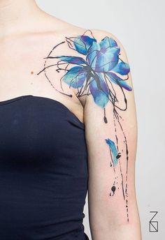 a woman's arm with blue flowers on it