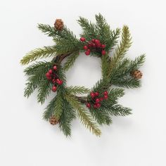 a christmas wreath with pine cones and red berries