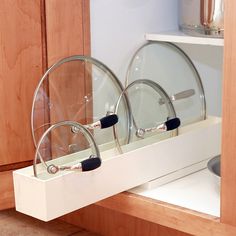 the dish rack is holding two dishes in it's holder, and has wheels on each side