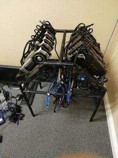 several bikes are stacked on top of each other in a room with carpeted flooring