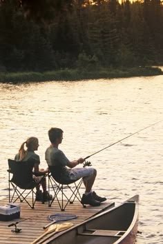 two people sitting in chairs on a dock fishing