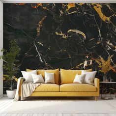 a yellow couch sitting in front of a black and gold marble wallpapered room