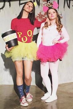 two girls dressed in costumes standing next to each other