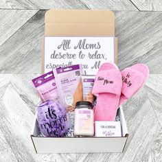 the mother's day gift box is packed with pink slippers and personal care items