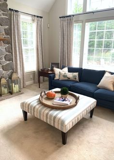 a living room filled with furniture and windows