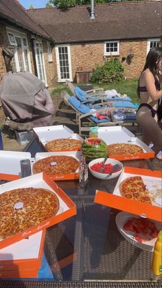 several pizzas are sitting on the table outside