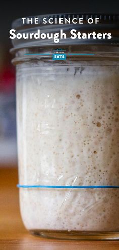 the science of sourdough starterrs in a glass jar on a wooden table