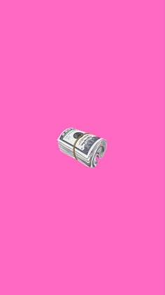 a roll of money on a pink background