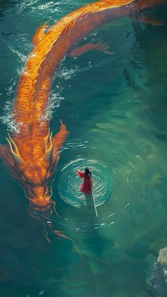 a person in the water with a paddle near a large orange fish that is swimming