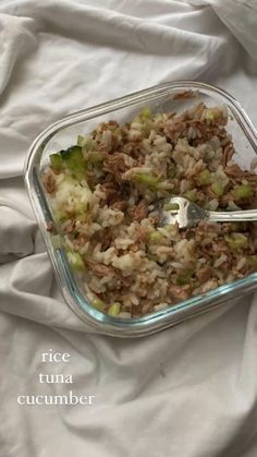 a glass dish filled with rice and meat