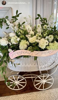 a white baby carriage with flowers in it