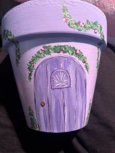 a painted pot with a purple door on it