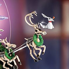 a christmas ornament with two reindeers pulling a sleigh