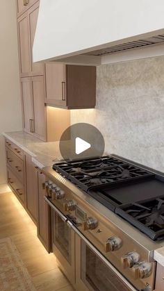 a stove top oven sitting inside of a kitchen next to wooden cabinets and counter tops