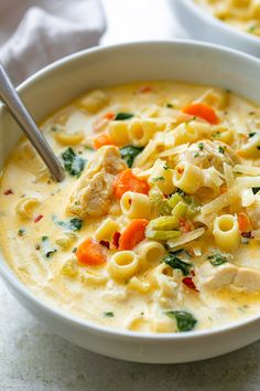 two bowls filled with pasta and chicken soup