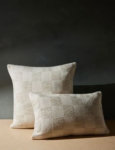 two white pillows sitting on top of a table