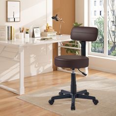 a brown office chair sitting on top of a wooden floor next to a white desk