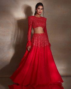 Deep vermillion georgette lehenga featuring self-pearl, glass bead & tassel embroidery paired with a power shoulder heavily embellished matching blouse with a tie back. The set comes with a ruffle organza & georgette dupatta.From Shloka Khialani's Winter Sun collection.DELIVERY TIMEPlease allow 6-8 weeks for your outfit to arrive.FABRIC DETAILSGeorgette, Net, OrganzaProfessional cleaning only. Sweetheart Blouse, Tiered Lehenga, Tassel Embroidery, Ruffle Dupatta, Cape Lehenga, Kurta Lehenga, Georgette Lehenga, Georgette Dupatta, Lehenga Skirt