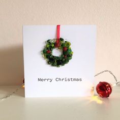 a card with a christmas wreath on it