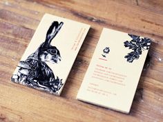 two business cards with an image of a rabbit on one side and a bird on the other