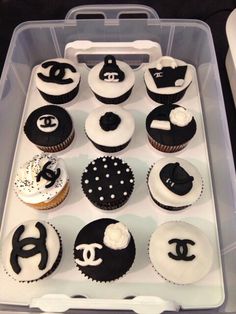 cupcakes with black and white frosting in a plastic container