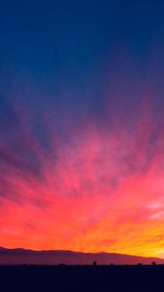 the sky is very colorful at sunset with clouds