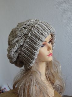 a mannequin head wearing a knitted hat