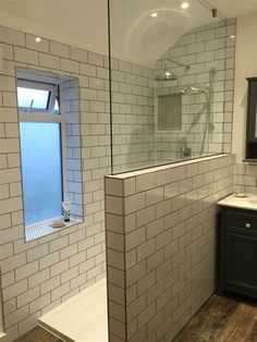 a bathroom with a shower, sink and mirror