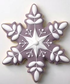 a decorated snowflake cookie with white frosting