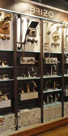 a display case filled with lots of different types of metal and glass items on shelves