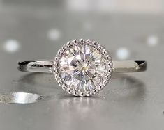 a diamond ring sitting on top of a table