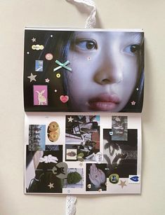 a collage of pictures and stickers on the wall above a woman's face