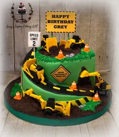 a birthday cake made to look like a construction site with dirt and road signs on it