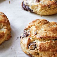 three biscuits sitting on top of a baking sheet