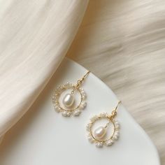 These stunning earrings are crafted for special occasions. Made with lustrous freshwater pearls and 14K gold filled, they exude elegance and charm. Their chandelier style adds a touch of sophistication to any outfit. The gold circles adorned with delicate white crystal beads enhance their beauty, culminating in a freshwater teardrop pearl that gracefully hangs in the center. Perfect for brides or anyone looking to add a touch of bridal elegance to their ensemble. These earrings are sure to make Pearl Circle Earrings, Party Accessories Jewelry, Art Nouveau Earrings, Pearl Earrings Handmade, Real Pearl Earrings, Bridal Statement Earrings, Art Nouveau Earring, Pretty Jewelry Necklaces, Crystal Chandelier Earrings