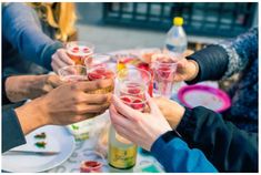 several people are toasting with wine glasses