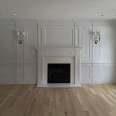 an empty living room with white walls and wood floors