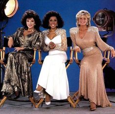 three women sitting on chairs in front of a camera