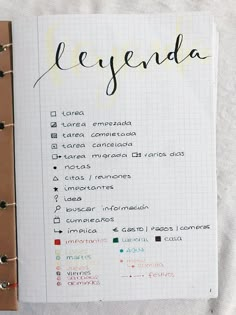 an open notebook with the word agenda written in cursive writing on top of it